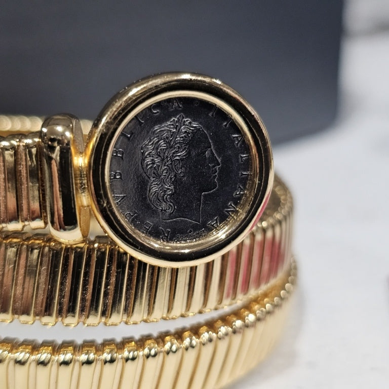 $125 Bellezza coin coil bracelet New This exquisite Bellezza coin coil bracelet showcases a unique design, combining classic charm with contemporary elegance. The bracelet features a series of intricate coils, highlighted by two distinct coin elements em