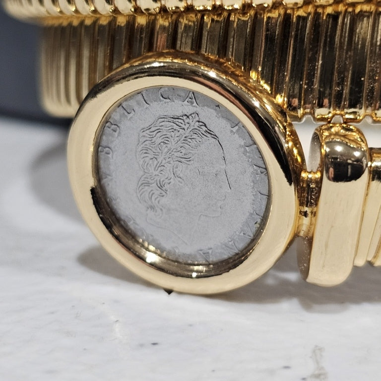 $125 Bellezza coin coil bracelet New This exquisite Bellezza coin coil bracelet showcases a unique design, combining classic charm with contemporary elegance. The bracelet features a series of intricate coils, highlighted by two distinct coin elements em