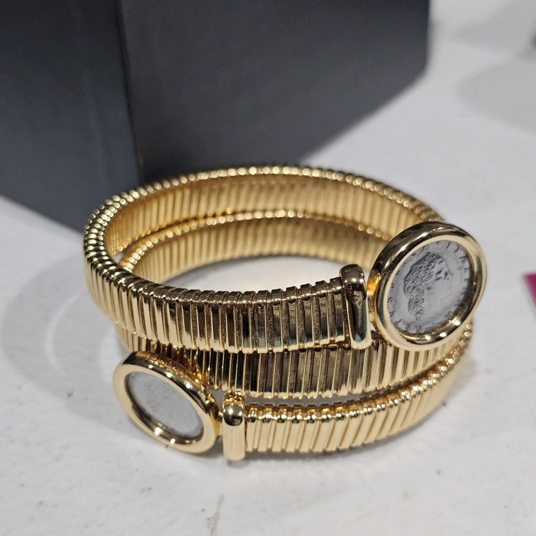 $125 Bellezza coin coil bracelet New This exquisite Bellezza coin coil bracelet showcases a unique design, combining classic charm with contemporary elegance. The bracelet features a series of intricate coils, highlighted by two distinct coin elements em